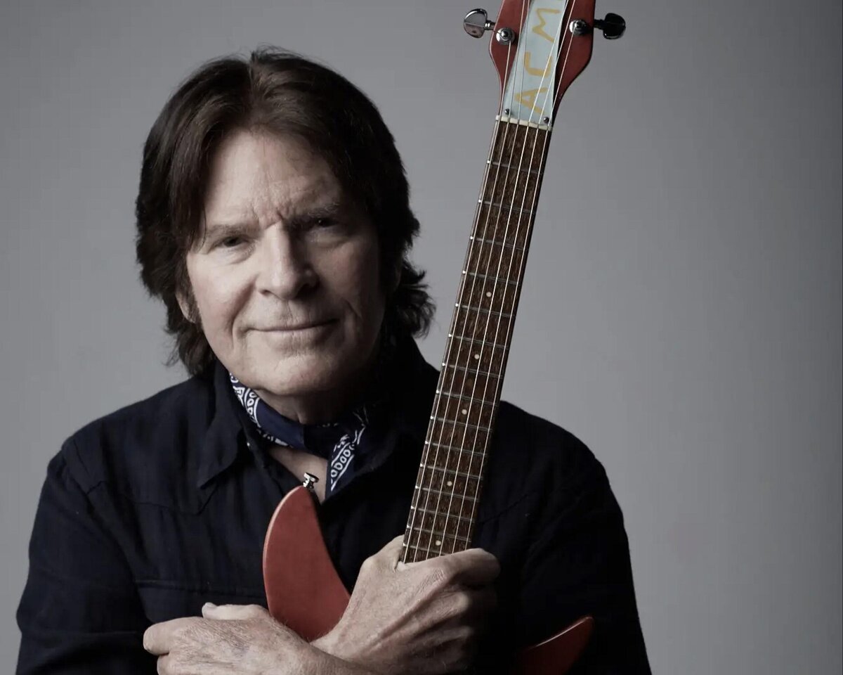 John Fogerty in later years, cradling his red Rickenbacker guitar against his chest