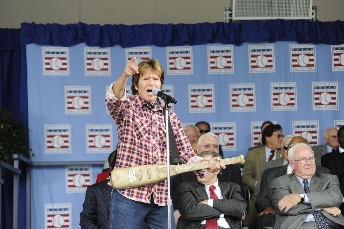 John Fogerty performing with his bat guitar at the National Baseball Hall of Fame ceremony